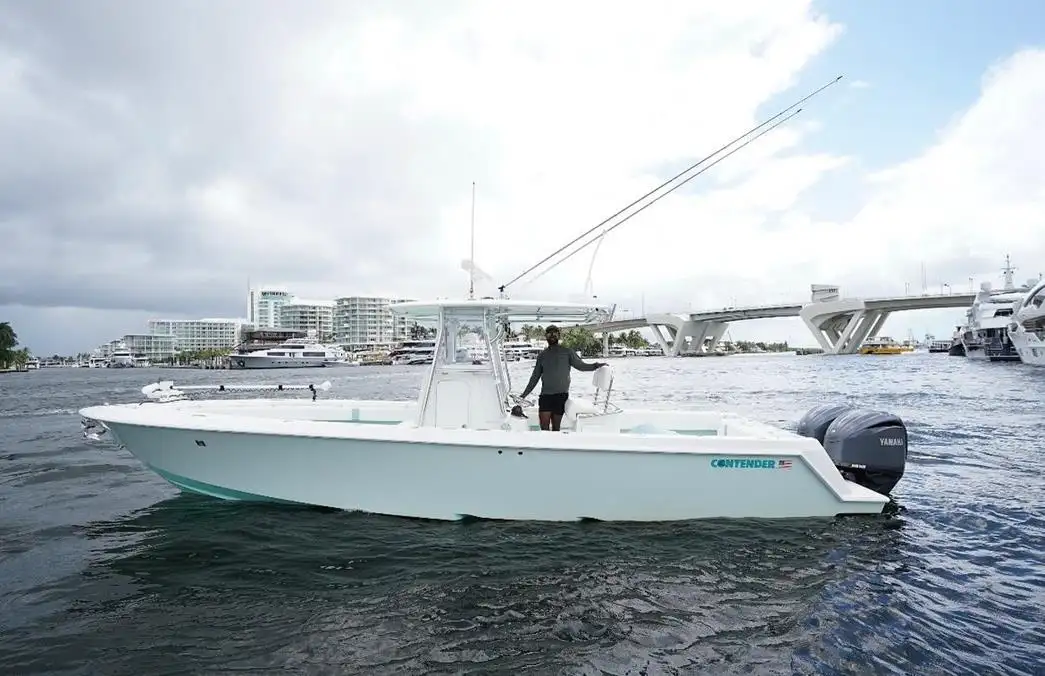 The Cool Runnings 32 ft Contender on the Intracoastal with Captain Jason at the helm, Fort Lauderdale skyline in the background