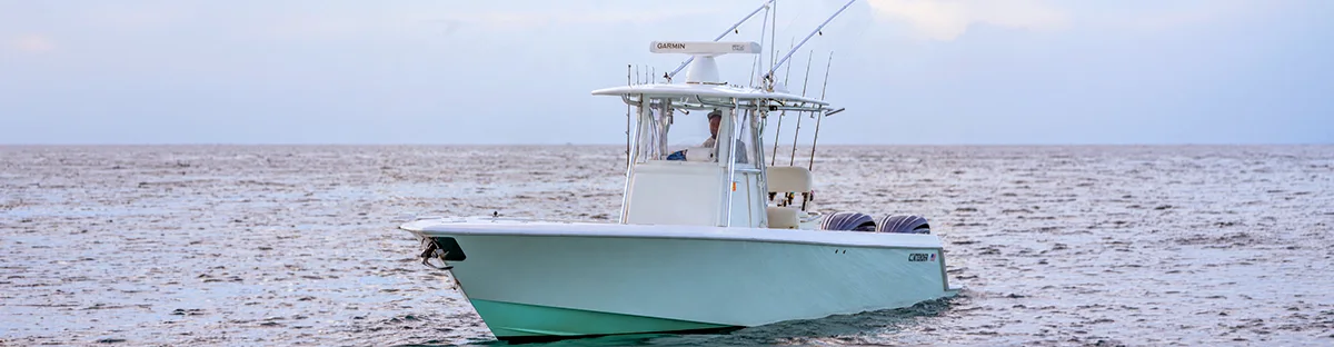 The Cool Runnings 32 ft Contender on the open water off Fort Lauderdale, T-top, Garmin radar, and twin Yamaha outboards visible