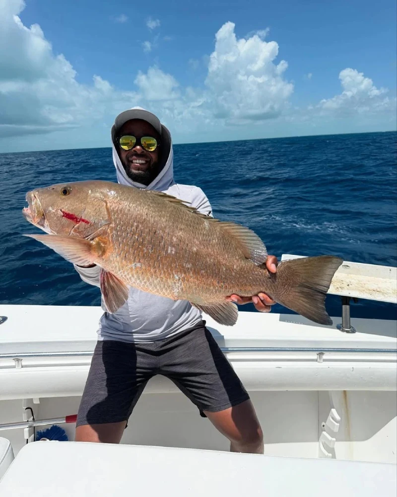 Anglers enjoying a deep sea fishing trip in Fort Lauderdale, reeling in big catches on a charter boat